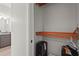 A walk-in closet with built in shelving, next to the bathroom with gray vanity at 4109 Cobia Ct, Palmetto, FL 34221