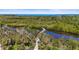 Scenic elevated boardwalk winding through lush greenery and water, leading towards the ocean at 4109 Cobia Ct, Palmetto, FL 34221