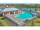 Community pool and lounge area with lake view; surrounded by chairs and tables for relaxing by the water at 4206 112Th E St, Palmetto, FL 34221