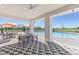 A well-appointed poolside lounge area with comfortable seating and open views of the pool and lake at 4206 112Th E St, Palmetto, FL 34221