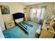 Bright bedroom with blue carpet, window, and closet at 425 30Th W Ave # C112, Bradenton, FL 34205