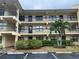 Exterior of the building showing multiple units with balconies and well-maintained landscaping at 425 30Th W Ave # C112, Bradenton, FL 34205