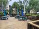 Community deck with plenty of seating, umbrellas, and well-maintained landscaping at 425 30Th W Ave # C112, Bradenton, FL 34205