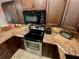 The modern kitchen features stainless steel appliances, granite countertops, and ample cabinet space for storage at 425 30Th W Ave # C112, Bradenton, FL 34205