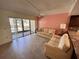 Bright living room featuring tile flooring, a ceiling fan, and sliding glass doors to the lanai at 425 30Th W Ave # C112, Bradenton, FL 34205