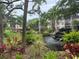 Beautiful pond with a waterfall feature surrounded by lush landscaping and trees at 425 30Th W Ave # C112, Bradenton, FL 34205