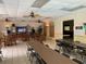 Community room with ceiling fans, tile floor, tables, chairs, TV and other recreational amenities at 425 30Th W Ave # C112, Bradenton, FL 34205