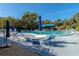 A sparkling community pool features ample seating, umbrellas, and lush landscaping, perfect for relaxation at 425 30Th W Ave # C208, Bradenton, FL 34205