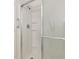 Modern shower with sleek glass door, chrome fixtures, and convenient built-in shelving at 425 30Th W Ave # C208, Bradenton, FL 34205