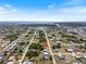 An aerial view shows the neighborhood of single-story homes and the waterways in the distance at 425 Skylark Nw Ln, Port Charlotte, FL 33952