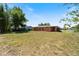 Large grassy backyard showcases property and exterior of adjacent house at 425 Skylark Nw Ln, Port Charlotte, FL 33952