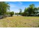 Expansive backyard featuring lush green grass and perimeter privacy fence at 425 Skylark Nw Ln, Port Charlotte, FL 33952