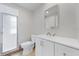 Clean bathroom featuring a glass shower, toilet, and vanity with sink and mirror at 425 Skylark Nw Ln, Port Charlotte, FL 33952