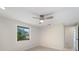 Bright bedroom with a ceiling fan and a window overlooking the yard at 425 Skylark Nw Ln, Port Charlotte, FL 33952