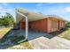 Orange home's carport with room for parking and stylish exterior architectural details at 425 Skylark Nw Ln, Port Charlotte, FL 33952