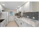 Clean kitchen featuring white cabinets, stainless steel appliances, and granite countertops at 425 Skylark Nw Ln, Port Charlotte, FL 33952