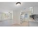 Modern kitchen with white cabinets, stainless steel appliances, and an open layout into the living room at 425 Skylark Nw Ln, Port Charlotte, FL 33952
