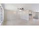 Light-filled living room showcasing new floors and a view into an adjacent kitchen area at 425 Skylark Nw Ln, Port Charlotte, FL 33952