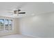 Bright living room featuring large windows, neutral paint, and a ceiling fan at 425 Skylark Nw Ln, Port Charlotte, FL 33952