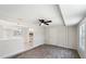 Spacious living area with ceiling fan and wood floors, open to the kitchen at 425 Skylark Nw Ln, Port Charlotte, FL 33952