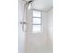 Close up of updated shower head and window in tiled shower area at 425 Skylark Nw Ln, Port Charlotte, FL 33952