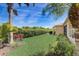 Lush backyard with manicured lawn, mature trees, and well-maintained landscaping for outdoor enjoyment at 4250 Turnberry Cir, North Port, FL 34288