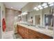 Beautiful bathroom featuring double sinks with granite countertops, decorative lighting, and a glass walk-in shower at 4250 Turnberry Cir, North Port, FL 34288