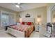 Bedroom featuring window with shutters, ceiling fan, quilt covered bed, and traditional décor at 4250 Turnberry Cir, North Port, FL 34288