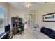 Comfortable bedroom featuring a stylish sofa, neutral carpet, and a built-in desk with backyard views at 4250 Turnberry Cir, North Port, FL 34288