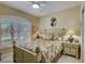 Relaxing bedroom with tropical bedding, plantation shutters, and decorative lighting at 4250 Turnberry Cir, North Port, FL 34288