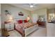 Bedroom with ceiling fan, traditional decor, and bed with decorative pillows and quilt at 4250 Turnberry Cir, North Port, FL 34288