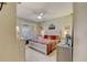 Bright bedroom with plantation shutters, ceiling fan, and bed with decorative pillows and quilt at 4250 Turnberry Cir, North Port, FL 34288