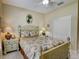 Cozy bedroom with tropical-themed decor, plantation shutters, and a closet at 4250 Turnberry Cir, North Port, FL 34288