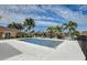 Community pool with ample seating and well-maintained landscaping on a sunny day at 4250 Turnberry Cir, North Port, FL 34288