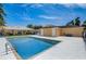 A community pool surrounded by lush landscaping and a building with beige exterior at 4250 Turnberry Cir, North Port, FL 34288