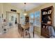 Elegant dining area showcasing a wooden table, stylish decor, and plantation shutters, with views into the adjacent living spaces at 4250 Turnberry Cir, North Port, FL 34288