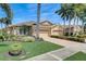 Stunning single-Gathering home with a three-car garage, paver driveway, lush landscaping, and soaring palm trees against a clear sky at 4250 Turnberry Cir, North Port, FL 34288