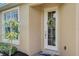 Inviting front entrance showcasing a decorative glass door, complemented by tasteful landscaping and a 'Welcome Friends' doormat at 4250 Turnberry Cir, North Port, FL 34288