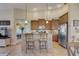 Well-appointed kitchen with a bar area, stainless steel appliances, and pendant lighting, offering a blend of style and functionality at 4250 Turnberry Cir, North Port, FL 34288