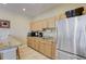 Clubhouse kitchenette featuring stainless steel refrigerator and light wood cabinetry at 4250 Turnberry Cir, North Port, FL 34288
