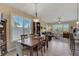 Open-concept living and dining area with tile floors, plantation shutters, and a seamless flow perfect for entertaining and relaxation at 4250 Turnberry Cir, North Port, FL 34288