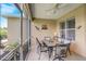 Inviting outdoor dining area with ceiling fan and scenic views of the green backyard and lush landscaping at 4250 Turnberry Cir, North Port, FL 34288