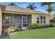 A lovely screened patio area with outdoor seating and views of the lush, green backyard at 4250 Turnberry Cir, North Port, FL 34288