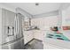 Updated kitchen boasts stainless steel refrigerator and appliances, with ample counter space at 4409 Maceachen Blvd, Sarasota, FL 34233