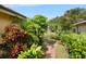 Lush tropical landscaping surrounds this home's beautiful water view and verdant lawn at 4622 Meadowview Cir, Sarasota, FL 34233