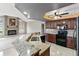 Open kitchen featuring granite countertops, dark wood cabinets, and modern black appliances at 4622 Meadowview Cir, Sarasota, FL 34233