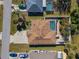 Aerial view of a single-Gathering home with a backyard pool and landscaped yard surrounded by lush greenery and neighboring houses at 4655 Payne St, North Port, FL 34287