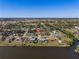 Aerial view of a single-Gathering home near a lake, with lush landscaping and easy access to the waterfront at 4655 Payne St, North Port, FL 34287