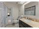 Bathroom with tile flooring, updated vanity, and access door to the backyard at 4655 Payne St, North Port, FL 34287
