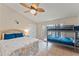 Cozy bedroom with a full-size bed, bunk beds, ceiling fan, and large windows, offering a comfortable and inviting space at 4655 Payne St, North Port, FL 34287